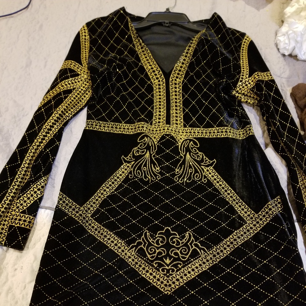 A black velvet mini dress with gold trim